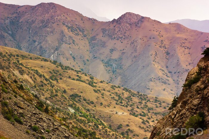 Canvas achtergrond gelaagde bergen heuvels bij zonsondergang
