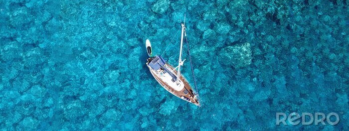 Canvas Aerial drone photo of luxury sail boat docked in tropical exotic bay with turquoise crystal clear sea