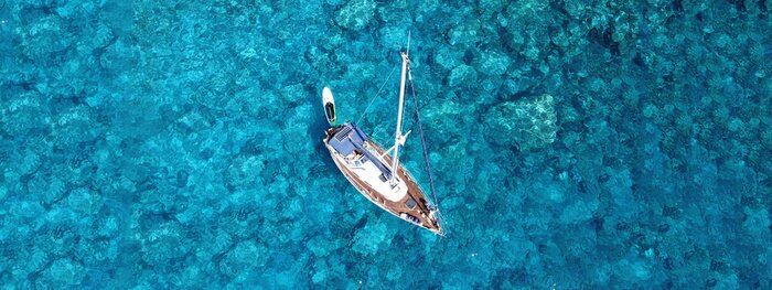 Canvas Aerial drone photo of luxury sail boat docked in tropical exotic bay with turquoise crystal clear sea