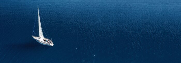 Canvas Aerial drone ultra wide photo of beautiful sail boat cruising in Aegean deep blue sea