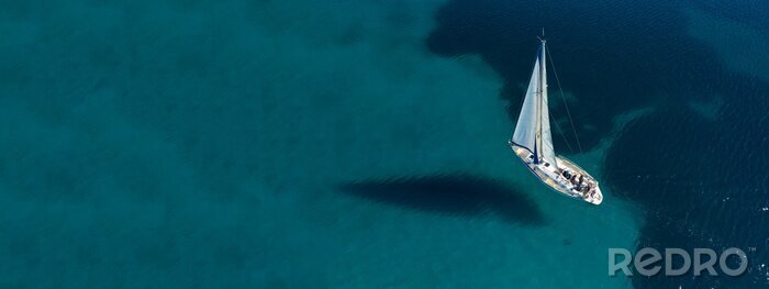 Canvas Aerial drone ultra wide photo of beautiful sail boat sailing in tropical exotic bay with emerald clear sea