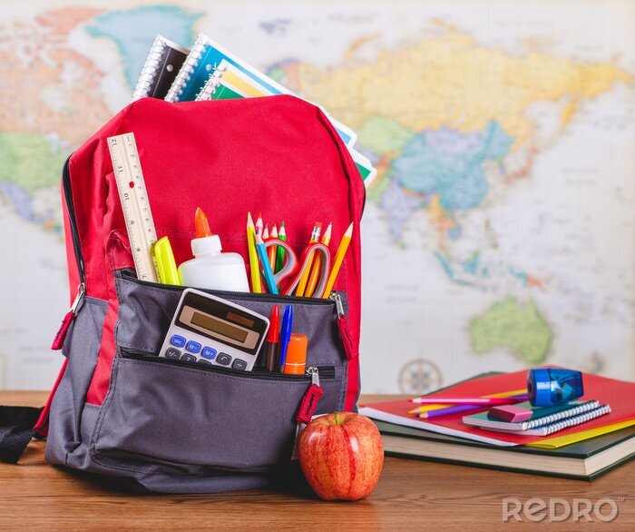 Canvas Backpack With School Supplies on a Desk