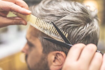 Canvas Barber cutting and modeling hair with scissors and comb.