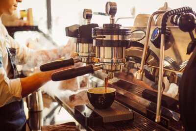 Canvas barista make coffee latte art with coffee espresso machine in coffee shop cafe in vintage color tone