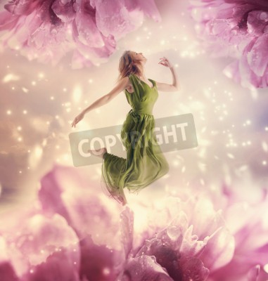 Canvas Beautiful young woman jumping on a giant flower
