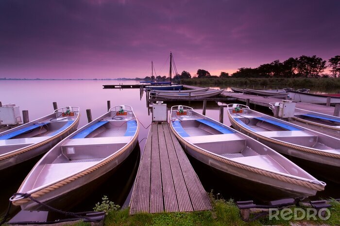 Canvas boten door pijler op meer toevluchtsoord tijdens zonsopgang