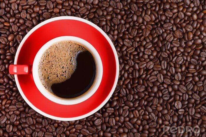 Canvas coffee background of hot black coffee in red cup on roasted arabica coffee beans background