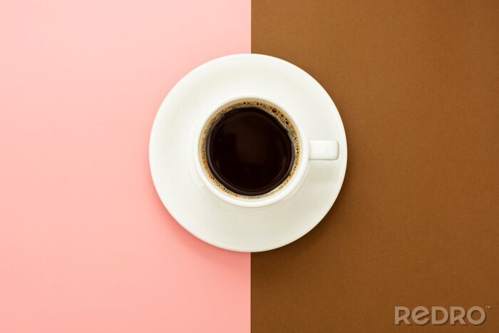 Canvas Coffee cup isolated on brown and pink table. Top view, flat lay abstract black coffee drink with copy space.