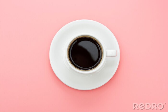 Canvas Coffee cup isolated on pink table. Top view, flat lay abstract black coffee drink with copy space.