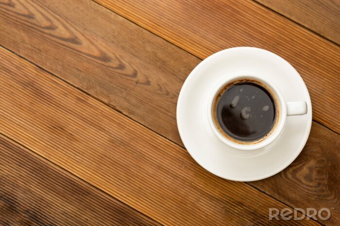 Canvas Coffee cup isolated on wooden table. Top view, flat lay coffee drink with copy space.