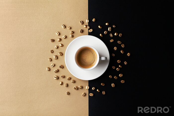 Canvas Cup of coffee and coffee beans on gold black background. Creative flat lay. Top view.