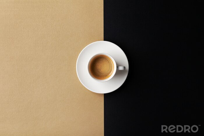Canvas Cup of coffee on gold black background. Minimalistic flat lay. Top view.