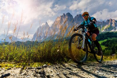 Canvas Cycling outdoor adventure in Dolomites. Cycling woman in Dolomites landscape. Woman cycling MTB enduro trail track. Outdoor sport activity.