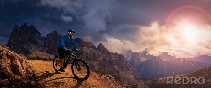 Canvas Cycling outdoor adventure. Man cycling on electric bike, rides mountain trail. Man riding on bike in Dolomites mountains landscape. Cycling e-mtb enduro trail track. Outdoor sport activity.