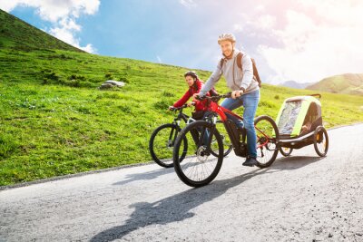 Canvas Family With Child In Trailer Riding Mountain Bikes