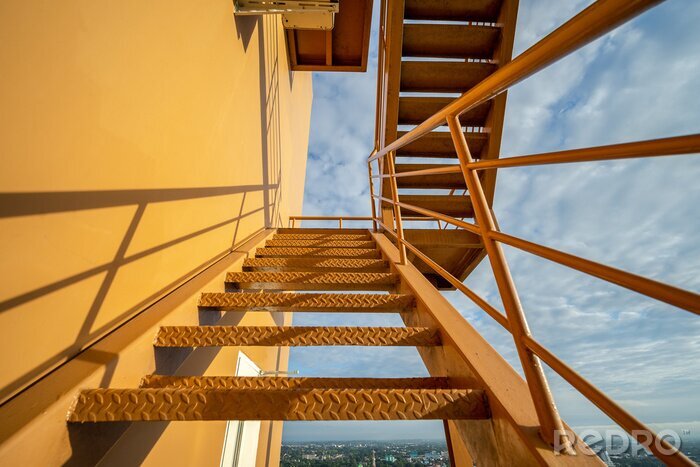 Canvas Fire escape stairs mounted to the outside, Emergency exit with yellow wall..