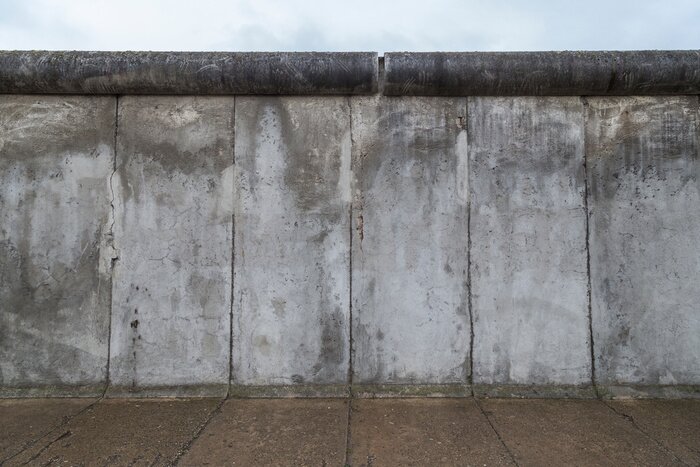 Canvas Front view of a section of the original Berlin Wall at the Berlin Wall Memorial (Berliner Mauer) in Berlin, Germany, on a cloudy day.