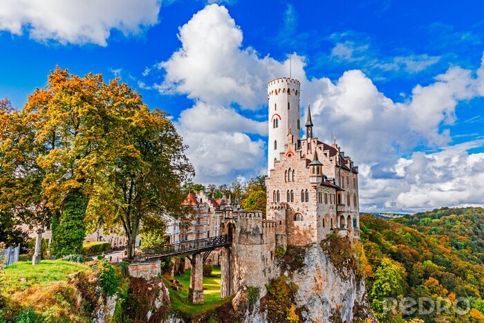 Canvas Germany, Lichtenstein Castle in Baden-Wurttemberg land in Swabian Alps. Seasonal view of Lichtenstein Castle on a cliff circled by trees with yellow foliage. European famous landmark.
