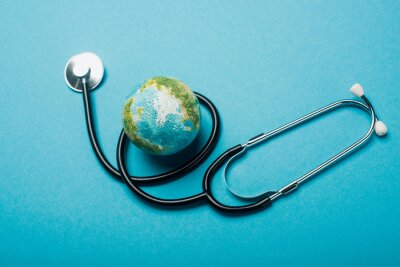 Canvas Globe and stethoscope on blue background, world health day concept