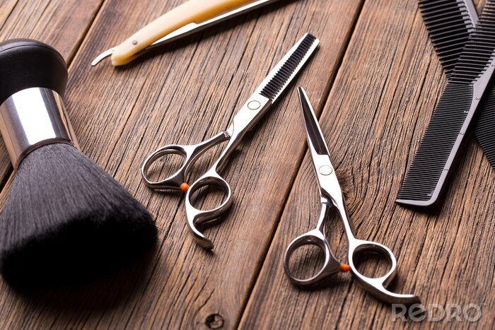Canvas Hairdressing tool kit. Scissors and other tool barber. Barber set. Barber tool on a wooden table. Scissors, comb for hair and a razor close-up.