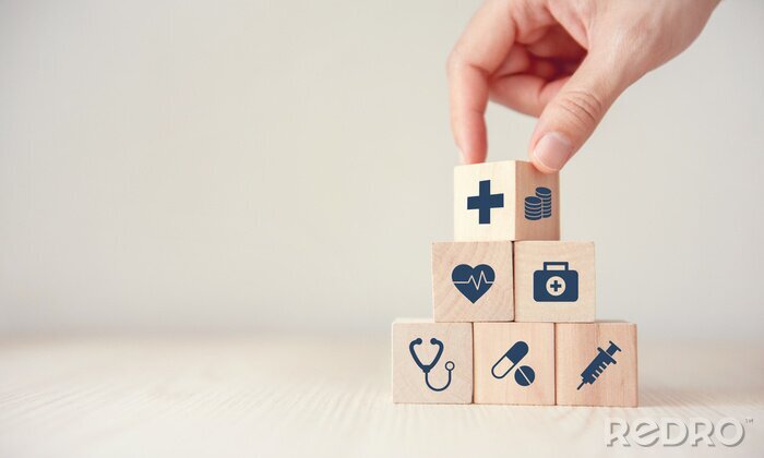 Canvas Health Insurance Concept, Hand arranging wood cube stacking with icon healthcare medical on wood background, copy space, financial concept.