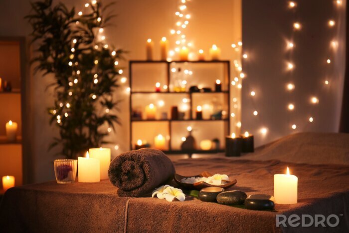 Canvas Massage stones with towel and candles on table in spa salon