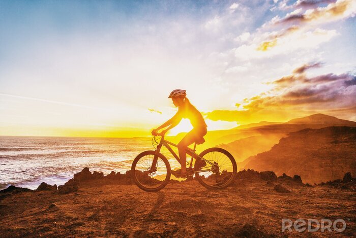 Canvas MTB mountain biking cyclist woman rider riding bike on summer coastal trail sunset landscape. Girl silhouette of athlete doing cycle sports outdoor. Healthy and Active lifestyle.