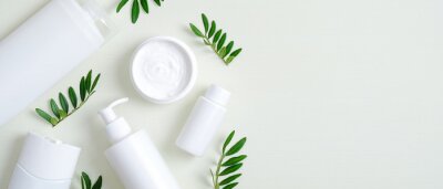 Canvas Natural organic SPA cosmetic products set with green leaves. Top view herbal skincare beauty products on green background. Banner mockup for eco shop or beauty salon. Flat lay minimalist style