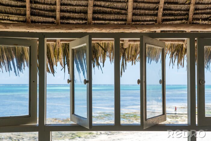 Canvas Open windows of thatched roof veranda overlooking the turquoise ocean on the island of Zanzibar, Tanzania, Africa