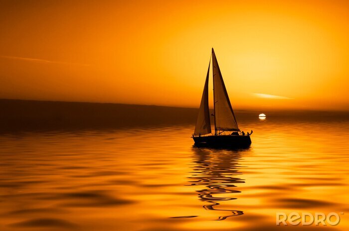 Canvas Oranje zonsondergang en een bootje