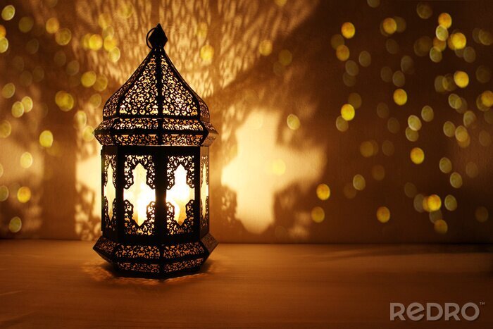 Canvas Ornamental Arabic lantern with burning candle glowing at night and glittering golden bokeh lights. Festive greeting card, invitation for Muslim holy month Ramadan Kareem. Dark background.