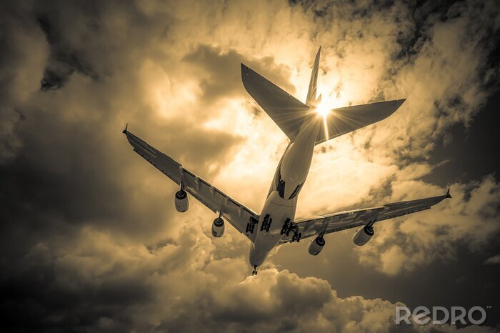 Canvas passagiersvliegtuig landing door gouden wolken