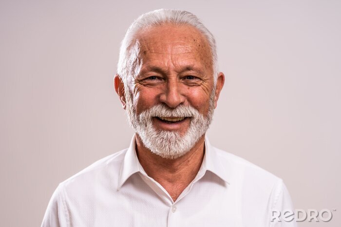 Canvas Portrait of cheerful senior man who is looking at camera and smiling.