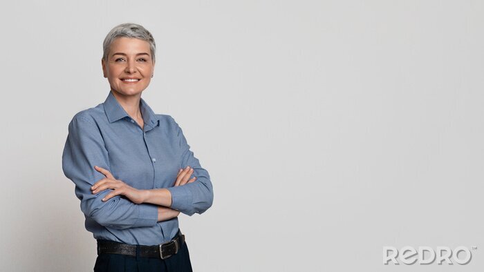 Canvas Portrait Of Mature Businesswoman Posing With Folded Arms Over Light Background
