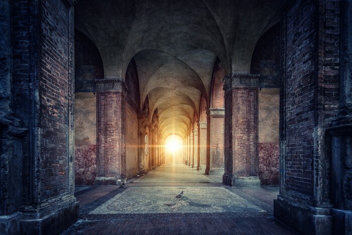 Canvas Rays of divine light illuminate old arches and columns of ancient buildings. Bologna, Italy. Conceptual image on historical, religious and travel theme.