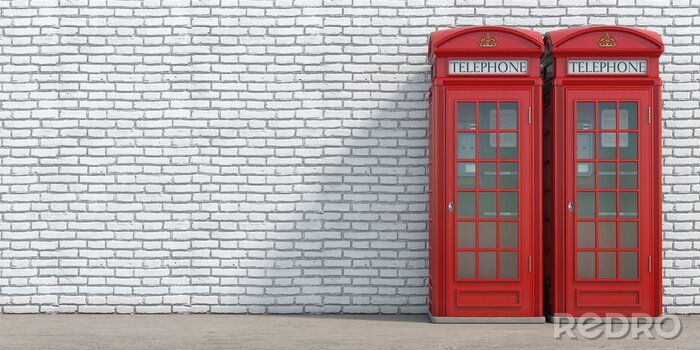 Canvas Red phone booth on brick wall background. London, british and english symbol.
