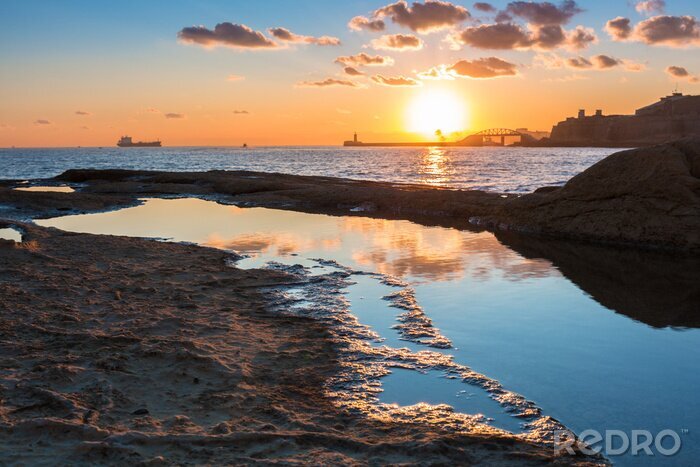 Canvas Rocky coastline of Malta and Mediterranean Sea at sunrise