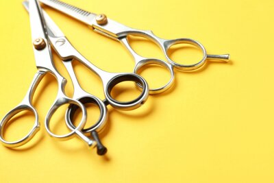 Canvas Scissors and space for text on color background, closeup. Hairdresser tools