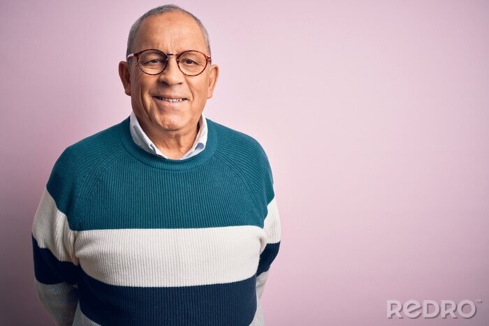 Canvas Senior handsome man wearing casual sweater and glasses over isolated pink background with a happy and cool smile on face. Lucky person.