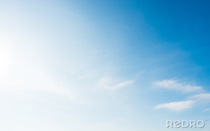 Canvas Soft blue sky with small white clouds and bright sun light