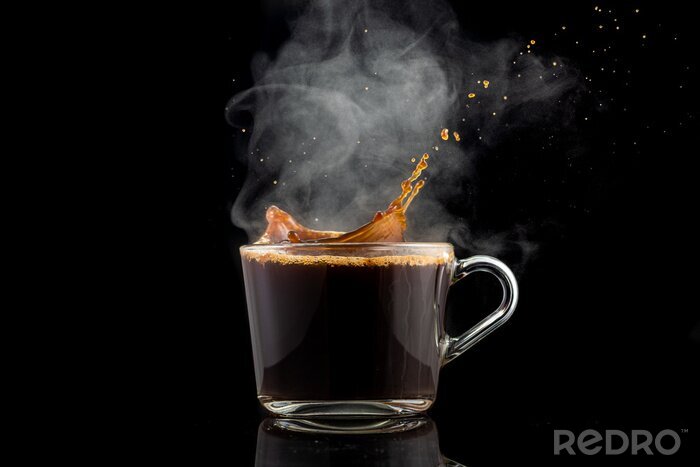 Canvas splash and splatter from a piece of sugar in a mug with coffee on a black background