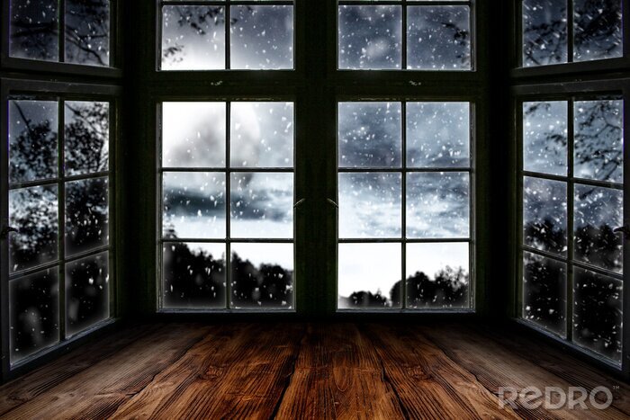 Canvas Table top board with big window background and beautiful snowy winter landscape outside. Moonlight winter night.