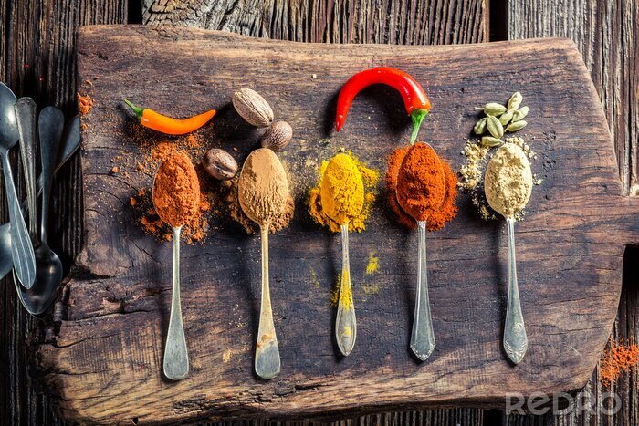 Canvas Tasty spices and herbs on old board
