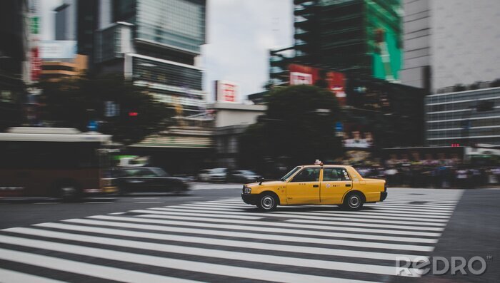 Canvas Taxi speeding across Shibuya crossing in Tokyo Japan