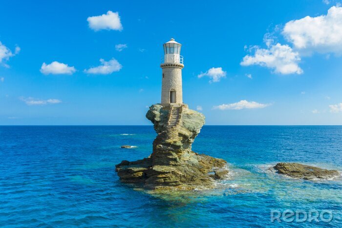 Canvas The beautiful Lighthouse Tourlitis of Chora in Andros island and a seagull, Cyclades, Greece