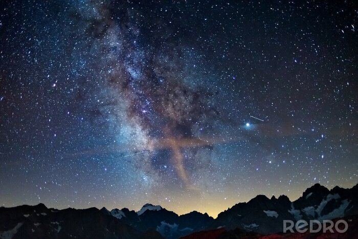 Canvas The Milky Way arch starry sky on the Alps, Massif des Ecrins, Briancon Serre Chevalier ski resort, France. Panoramic view high mountain range and glaciers, astro photography, stargazing