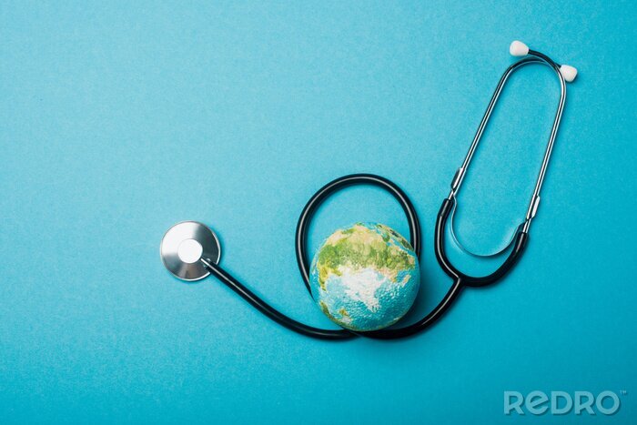 Canvas Top view of globe and stethoscope on blue background, world health day concept