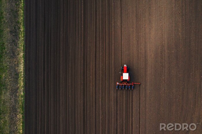 Canvas Top view of tractor planting corn seed in field