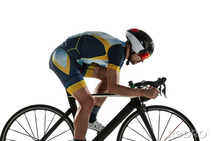 Canvas Triathlon male athlete cycle training isolated on white studio background. Caucasian fit triathlete practicing in cycling wearing sports equipment. Concept of healthy lifestyle, sport, action, motion.