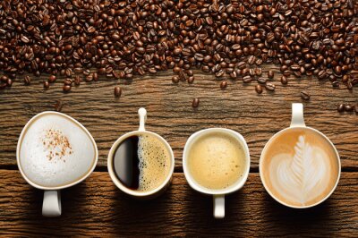 Verscheidenheid van kopjes koffie en koffie bonen op oude houten tafel